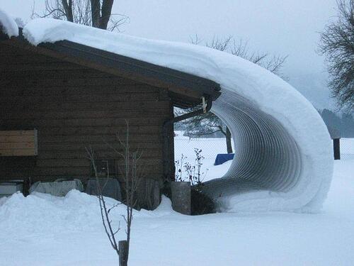 snow falling off a metal roof 